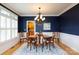 Elegant dining room with navy walls, hardwood floors, and a view into the kitchen at 1587 Summit View Dr, Rock Hill, SC 29732