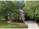 Charming brick home with lush landscaping and a winding driveway, offering curb appeal at 1587 Summit View Dr, Rock Hill, SC 29732
