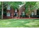 Two-story brick home featuring a well-maintained lawn and decorative shrubs enhancing curb appeal at 1587 Summit View Dr, Rock Hill, SC 29732