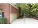 Red brick home featuring a two car garage, driveway and fenced in side yard at 1587 Summit View Dr, Rock Hill, SC 29732