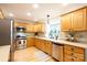 Well-lit kitchen featuring wooden cabinets, stainless steel appliances, and hardwood flooring at 1587 Summit View Dr, Rock Hill, SC 29732