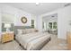 Bright bedroom showcasing a bed with neutral bedding, bedside tables, and large windows for natural light at 170 Aspire Cir # 31, Wingate, NC 28174