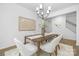 Charming dining room featuring modern decor, a wooden table, and six white upholstered chairs at 170 Aspire Cir # 31, Wingate, NC 28174