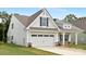 Side view of a lovely home with a two-car garage and manicured lawn at 170 Aspire Cir # 31, Wingate, NC 28174