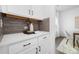 A kitchenette featuring quartz countertops, grey backsplash, and white shaker cabinets at 170 Aspire Cir # 31, Wingate, NC 28174