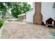 Brick paver patio with seating, a dog house and mature landscaping at 2008 Bantry Ln, Charlotte, NC 28262