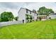 Beautiful backyard showcasing a well-manicured lawn, a white fence, and the home's architecture with a walkout basement at 2008 Bantry Ln, Charlotte, NC 28262