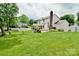 Spacious backyard with a well-maintained lawn, featuring a patio area and garden, ideal for outdoor enjoyment at 2008 Bantry Ln, Charlotte, NC 28262
