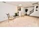 Finished basement space with carpet, neutral walls, seating and a staircase at 2008 Bantry Ln, Charlotte, NC 28262