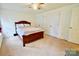 Spacious bedroom with neutral carpeting, ceiling fan, and double door closets for optimal storage solutions at 2008 Bantry Ln, Charlotte, NC 28262
