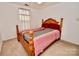 Bright bedroom featuring a wooden four-poster bed and natural light at 2008 Bantry Ln, Charlotte, NC 28262