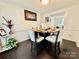 A cozy dining area boasts a round table set for four, with artwork, next to the living room at 2008 Bantry Ln, Charlotte, NC 28262