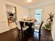 A cozy dining area boasts a round table set for four, next to the kitchen at 2008 Bantry Ln, Charlotte, NC 28262