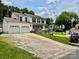 Traditional home with a two-car garage, a long driveway, and a welcoming front porch, set in a serene neighborhood at 2008 Bantry Ln, Charlotte, NC 28262