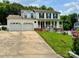 Charming two-story white home with a two-car garage, red brick accents, and a beautifully landscaped yard at 2008 Bantry Ln, Charlotte, NC 28262
