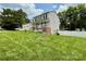 Charming home with a large front yard, featuring a porch swing, mature trees, and meticulous landscaping for inviting curb appeal at 2008 Bantry Ln, Charlotte, NC 28262