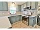 The kitchen features blue cabinets, stainless steel appliances, and tile backsplash at 2008 Bantry Ln, Charlotte, NC 28262