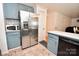 This kitchen features stainless steel appliances, blue cabinetry, and tile flooring at 2008 Bantry Ln, Charlotte, NC 28262