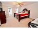 This main bedroom features carpet flooring, a ceiling fan, and natural light from two windows at 2008 Bantry Ln, Charlotte, NC 28262