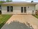 Well-maintained backyard featuring a small patio and white siding with a door leading inside at 2010 Kansas City Dr, Monroe, NC 28110