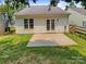 Well-maintained backyard featuring a small patio and white siding with a door leading inside at 2010 Kansas City Dr, Monroe, NC 28110