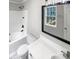 A full bathroom features a shower and tub, marble floors, and white vanity with a large mirror at 2010 Kansas City Dr, Monroe, NC 28110