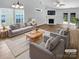 Bright living room with vaulted ceilings, a fireplace, and new hardwood flooring at 2010 Kansas City Dr, Monroe, NC 28110