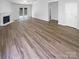 Spacious open floor plan featuring new hardwood flooring, fireplace, and access to backyard at 2010 Kansas City Dr, Monroe, NC 28110