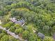 Wide aerial view of estate with a large house, swimming pool, pond, and surrounded by lush green trees at 2032 Greenbrook Pkwy, Matthews, NC 28104