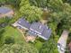 Aerial view of house with mature trees, lush lawn, and a wooden deck at 2032 Greenbrook Pkwy, Matthews, NC 28104