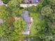 Aerial view of house with mature trees, lush lawn, garden, and a wooden deck at 2032 Greenbrook Pkwy, Matthews, NC 28104