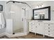 Bright bathroom with a tiled glass shower, double sink vanity, and wooden-look floors at 2032 Greenbrook Pkwy, Matthews, NC 28104