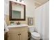 Cozy bathroom with a classic sink, toilet, framed mirror, and shower with white curtain at 2032 Greenbrook Pkwy, Matthews, NC 28104