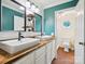 Bathroom with double sinks, wood countertop, and a door that leads to the toilet and shower at 2032 Greenbrook Pkwy, Matthews, NC 28104