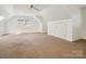 Spacious bonus room with carpet tiles and a large closet, perfect for storage or conversion at 2032 Greenbrook Pkwy, Matthews, NC 28104