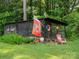 Backyard chicken coop structure with chickens and a decorative flag at 2032 Greenbrook Pkwy, Matthews, NC 28104