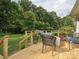 Inviting wooden deck with outdoor seating, lush greenery, and a beautiful backyard view at 2032 Greenbrook Pkwy, Matthews, NC 28104