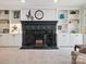 Elegant fireplace with brick accents and custom built-in shelving, creating a focal point in the living space at 2032 Greenbrook Pkwy, Matthews, NC 28104