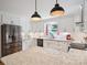 The kitchen features white cabinets, stainless steel appliances, granite countertops, and pendant lighting at 2032 Greenbrook Pkwy, Matthews, NC 28104