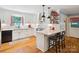 Well-lit kitchen with white cabinetry, granite countertops, a center island with seating, and modern appliances at 2032 Greenbrook Pkwy, Matthews, NC 28104