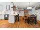 Bright kitchen featuring a center island with seating, white cabinetry, modern appliances, and hardwood floors at 2032 Greenbrook Pkwy, Matthews, NC 28104