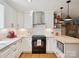 Well-lit kitchen has stainless appliances, white cabinets, granite countertops, hardwood floors, and modern fixtures at 2032 Greenbrook Pkwy, Matthews, NC 28104