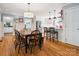 Open layout featuring a modern kitchen with an island and a cozy dining area with a wooden table and chairs at 2032 Greenbrook Pkwy, Matthews, NC 28104