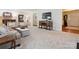 Spacious living room showcasing neutral decor, traditional console table, and multiple entryways creating an open floor plan at 2032 Greenbrook Pkwy, Matthews, NC 28104