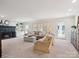 Spacious living room with a fireplace, neutral carpet, and large windows for natural light at 2032 Greenbrook Pkwy, Matthews, NC 28104