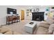 Bright living room with a fireplace, built-in shelves, a console table, and neutral furnishings creating a cozy atmosphere at 2032 Greenbrook Pkwy, Matthews, NC 28104