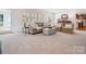 Inviting living room with shuttered windows, comfortable seating, and neutral colors creating a warm and relaxing ambiance at 2032 Greenbrook Pkwy, Matthews, NC 28104