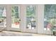 View through the patio doors onto the outdoor deck and backyard space at 2032 Greenbrook Pkwy, Matthews, NC 28104
