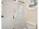 Modern shower with white subway tile, glass door, and decorative window with a view at 2032 Greenbrook Pkwy, Matthews, NC 28104