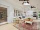Bright sunroom with brick walls, skylights, fan, sofa, and access to what appears to be a kitchen at 2032 Greenbrook Pkwy, Matthews, NC 28104